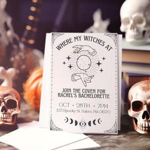 May include: A white card with black text and illustrations. The text reads "Where my witches at" and "Join the coven for Rachel's Bachelorette". The date and time of the event are listed as "Oct 28th + 7pm" and the address is "123 Spooky St. Salem, MA 01970".