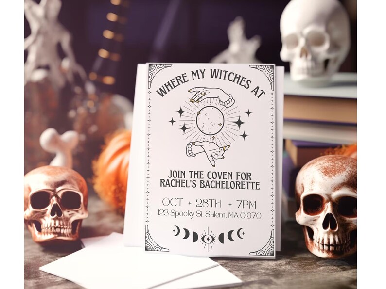 May include: A white card with black text and illustrations. The text reads "Where my witches at" and "Join the coven for Rachel's Bachelorette". The date and time of the event are listed as "Oct 28th + 7pm" and the address is "123 Spooky St. Salem, MA 01970".