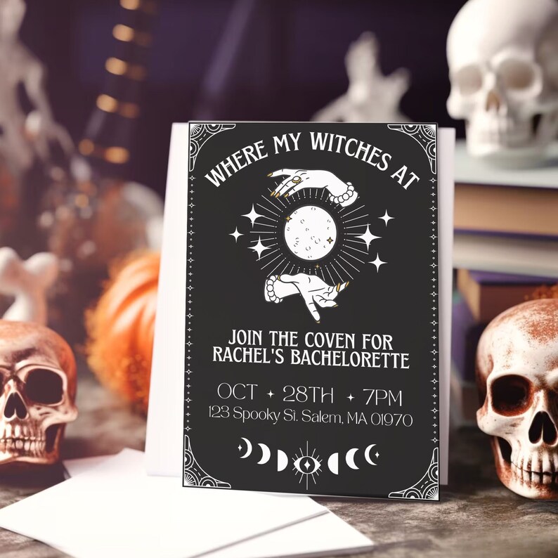 May include: Black and white invitation card with a witchy theme. It says "Where my witches at" and "Join the coven for Rachel's bachelorette" with a moon and stars graphic. The date and time are listed as "Oct 28th + 7pm" and the address is "123 Spooky St. Salem, MA 01970".