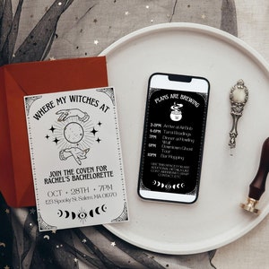 May include: A white card with black text and illustrations of hands holding a moon. The text reads "Where my witches at" and "Join the coven for Rachel's bachelorette Oct 28th 7pm 123 Spooky St Salem, MA 01070". A smartphone with a black screen displaying a schedule of events for a hen party. The text on the screen reads "Plans are brewing" and lists the times and activities for the day. The phone is on a white plate with a silver spoon and a wooden stamp.