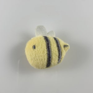 May include: A yellow plush bee with black stripes and white wings.
