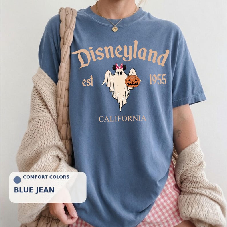 A blue t-shirt with a graphic of a ghost and a pumpkin, along with the text "Disneyland est 1955" and "California".