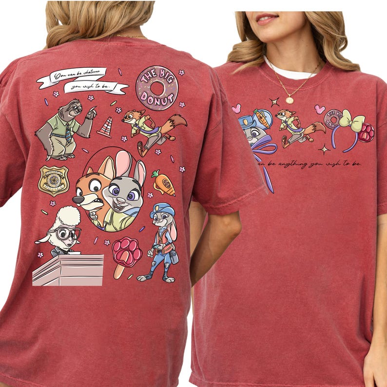 a red t-shirt with a colorful graphic design of cartoon characters and various objects, including a police officer, a rabbit, and other whimsical elements.