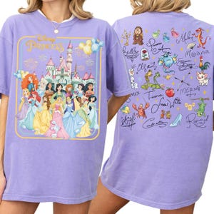 A purple t-shirt with a Disney Princess graphic and various Disney characters on the back.
