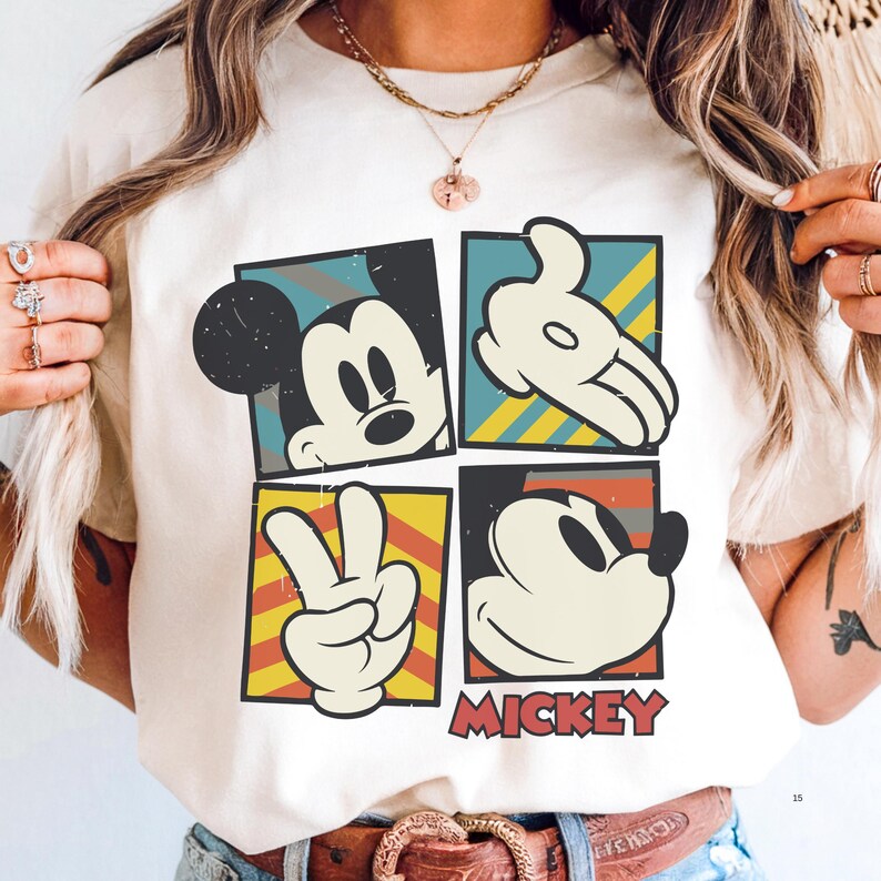 A person wearing a white t-shirt with a graphic of Mickey Mouse and the word "MICKEY" printed on it.