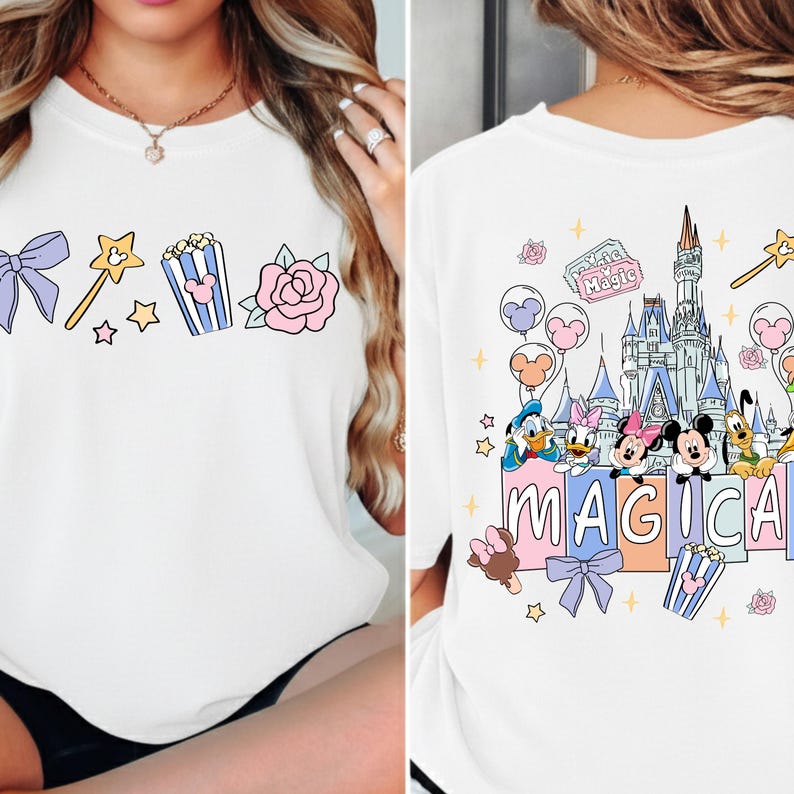 A white t-shirt with a Disney-themed design, featuring characters from the Disney film series and the word "MAGICA" prominently displayed.