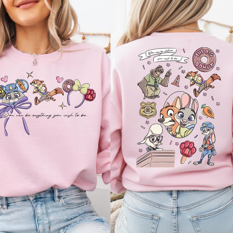 a woman wearing a pink sweatshirt with a cartoon character design on the back.