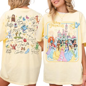 a yellow t-shirt with a Disney Princess graphic and various Disney characters on the back.