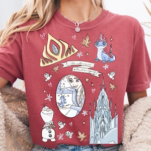 A red t-shirt with various cartoon characters and designs, including a princess, a dragon, and a castle.