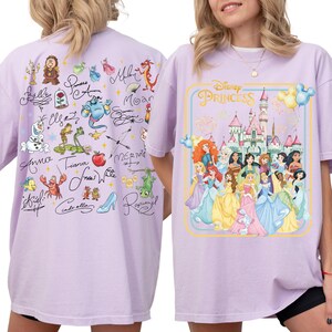 two different t-shirt designs. The back of the t-shirt has a collage of various Disney princess characters and their signatures, while the front of the t-shirt features a graphic of Disney princesses in a castle.