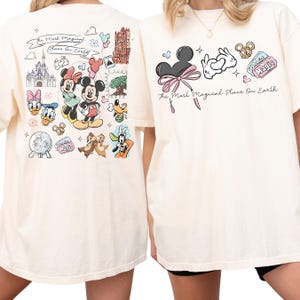 two white t-shirts with Disney-themed designs on the back and front.