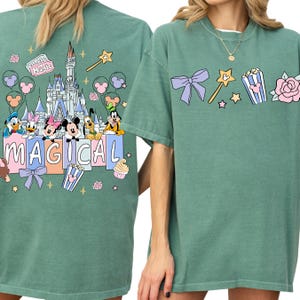 two green t-shirts with Disney-themed graphics and text.