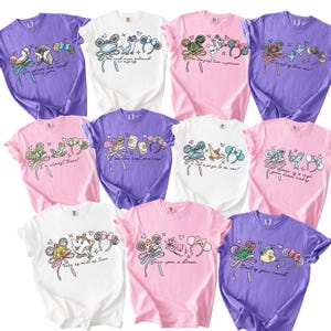 a collection of t-shirts with various colorful designs and text.