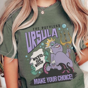 A green t-shirt with a graphic design featuring a character from the Disney animated film "The Little Mermaid".