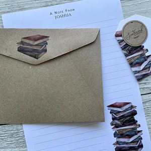 May include: A brown envelope with a stack of books illustration. A white lined sheet of paper with a stack of books illustration and the text "Sentimental" and "For You".