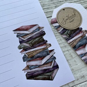 May include: A stack of vintage-style books with a brown, cream, and blue color scheme. The books are stacked on a white background with a tag that says "Scattered Seed Co."