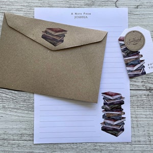 May include: A brown kraft paper envelope with a stack of books illustration. A white letter writing paper with a stack of books illustration. A white gift tag with a stack of books illustration and the text "Sentimental Treasures" and "For You".