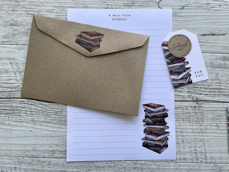 May include: A brown kraft paper envelope with a stack of books illustration. A white letter writing paper with a stack of books illustration. A white gift tag with a stack of books illustration and the text "Sentimental Treasures" and "For You".