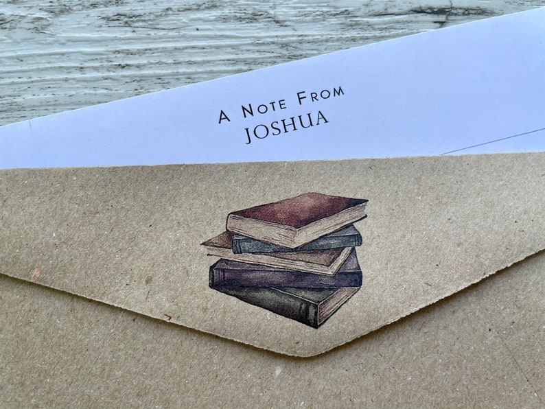 May include: A brown paper envelope with a white note that says "A Note From Joshua" and a watercolor illustration of a stack of books.