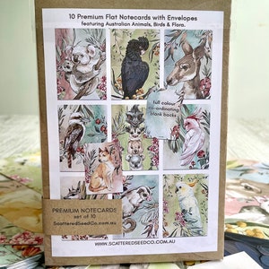 May include: A set of 10 premium flat notecards with envelopes. The cards feature colorful illustrations of Australian animals, birds, and flora. The packaging includes the text "Premium Notecards" and "ScatteredSeedCo.com.au".