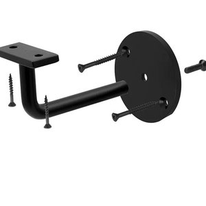 May include: Black metal handrail bracket with a rectangular mounting plate, a curved support arm, and a circular base plate. Includes several black screws for installation. The bracket is designed for mounting a handrail to a wall.