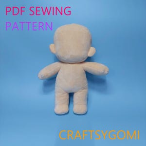 May include: A beige plush doll with a rounded head, small ears, arms, and legs, set against a blue background. The text "PDF SEWING PATTERN" is in pink and purple, and the text "CRAFTSYGOMI" is in orange.