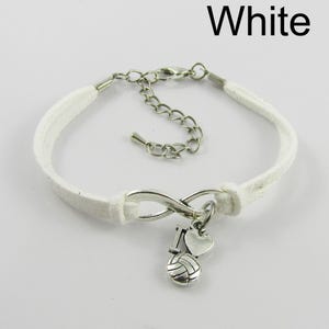 May include: White suede bracelet with an infinity charm and a volleyball charm with a heart charm that says "I" on it.