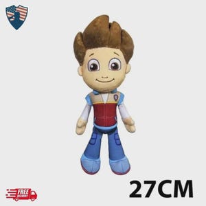 May include: A plush toy of a cartoon character, featuring brown hair, a tan face, and a red and blue outfit. The toy is approximately 10.6 inches tall. The image also includes the text "27CM".