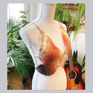 May include: A crocheted top with a brown, orange, and white ombre design. The top is made of a lightweight, breathable material and has a relaxed fit.