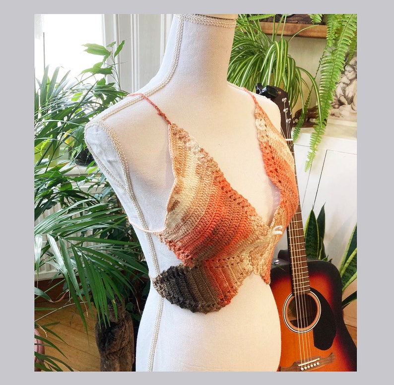 May include: A crocheted top with a brown, orange, and white ombre design. The top is made of a lightweight, breathable material and has a relaxed fit.