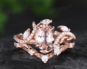 May include: Rose gold engagement ring set featuring a large oval morganite centre stone and smaller round and marquise diamonds set in a delicate floral design.