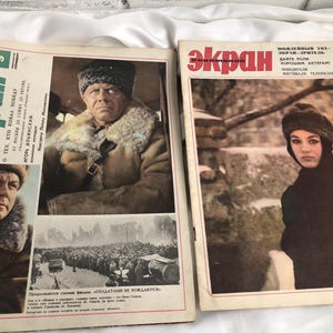 May include: Two vintage magazines with Russian text and images. One features a man in a fur hat and coat, the other a woman in a fur hat and coat. The magazines are from 1967.