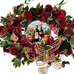 May include: A decorative wreath featuring a central circular design with the words "Wine O'clock" and images of wine bottles and a glass. The wreath is adorned with red and burgundy flowers, green leaves, and a burlap bow, creating a festive look.