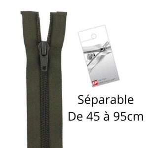 Puede incluir: Una cremallera separable de color verde oliva con un cursor y tirador a juego. Junto a la cremallera hay una etiqueta blanca con un gráfico de una cremallera y el texto "Eclair Prym FERMETURE ECLAIR". El texto "Séparable De 45 à 95cm" es visible.