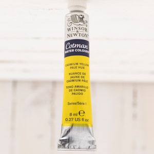 May include: A yellow tube of Winsor & Newton Cotman watercolors in Cadmium Yellow Pale Hue. The tube is labeled with the color name, shade, and series number. It contains 0.27 US fluid ounces of paint.