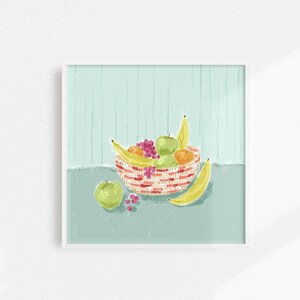 May include: A red and white striped bowl filled with fruit, including bananas, apples, and oranges. The bowl is sitting on a light blue surface.