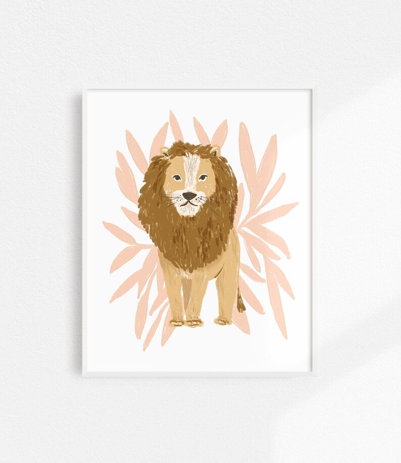 May include: A framed art print featuring a stylized lion illustration. The lion has a brown mane and body, with a white face. Behind the lion is a light pink floral design on a white background. The artwork is in a white frame.