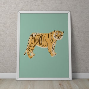 May include: A framed print of a tiger with orange and black stripes standing on a light green background.