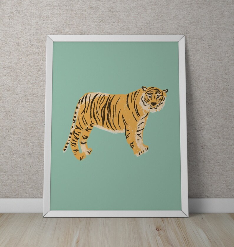 May include: A framed print of a tiger with orange and black stripes standing on a light green background.