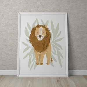 May include: A brown lion with a light brown mane stands in front of a green leafy background. The lion is looking directly at the viewer.