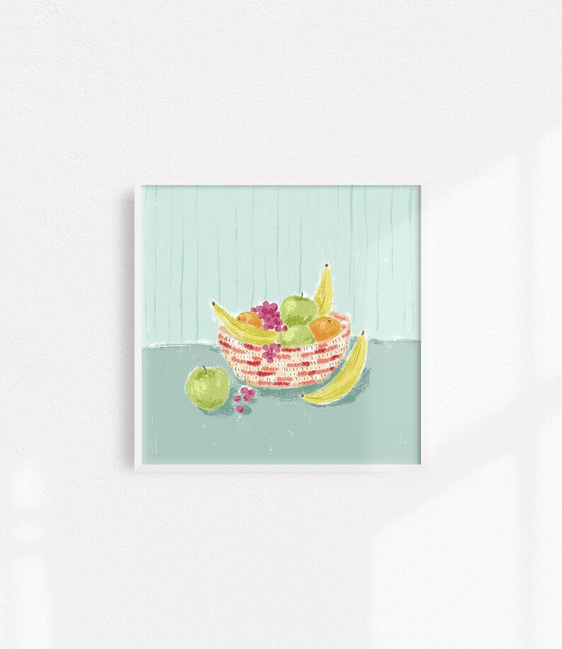 May include: A red and white striped bowl filled with fruit, including bananas, apples, and oranges. The bowl is sitting on a light blue surface.