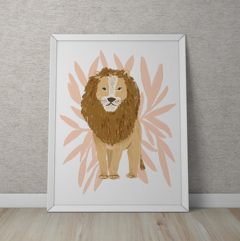 May include: A framed art print featuring a lion illustration. The lion is depicted in shades of brown and tan, with a prominent mane. Behind the lion are stylized, light pink leaf shapes. The artwork is framed in a white border.