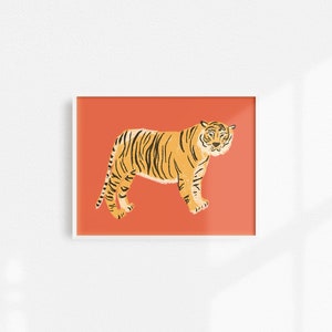 May include: A digital illustration of a tiger standing on a coral orange background. The tiger is facing the left side of the image and has black stripes.