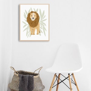 May include: A framed illustration of a brown lion standing in front of green leaves. The lion has a light brown mane and a white background.
