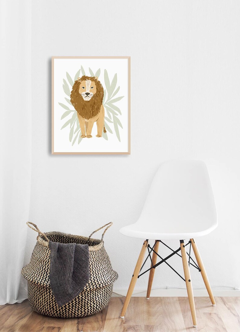 May include: A framed illustration of a brown lion standing in front of green leaves. The lion has a light brown mane and a white background.