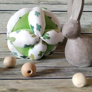 Green and white motility ball with cactus.