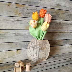 Bouquet of tulips in orange fabric.