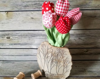 Bouquet of tulips in red fabric.
