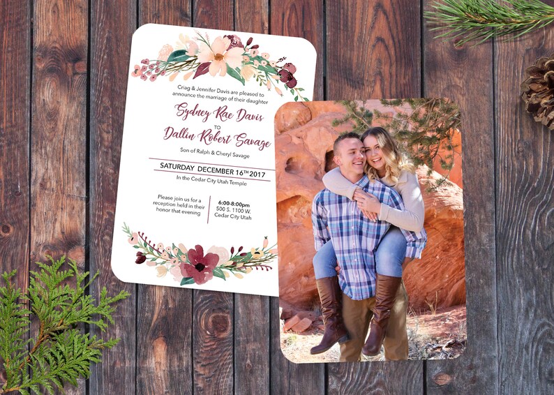 May include: Wedding invitation with floral design and a photo of a couple. The invitation announces the marriage of Sydney Rae Davis to Dallin Robert Savage on Saturday, December 16th, 2017 at the Cedar City Utah Temple. The reception will be held at 500 S. 1100 W. Cedar City, Utah from 6:00-8:00pm.