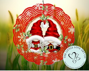 May include: Red and gold layered paper wind spinner with a white snowflake design. The center features two gnomes wearing red hats and white beards. The text "The Little Love Art Co. Printable Digital Paper & Graphics" is on the bottom right.
